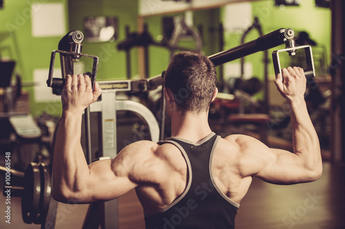 Handsom young man workout in fitness gym