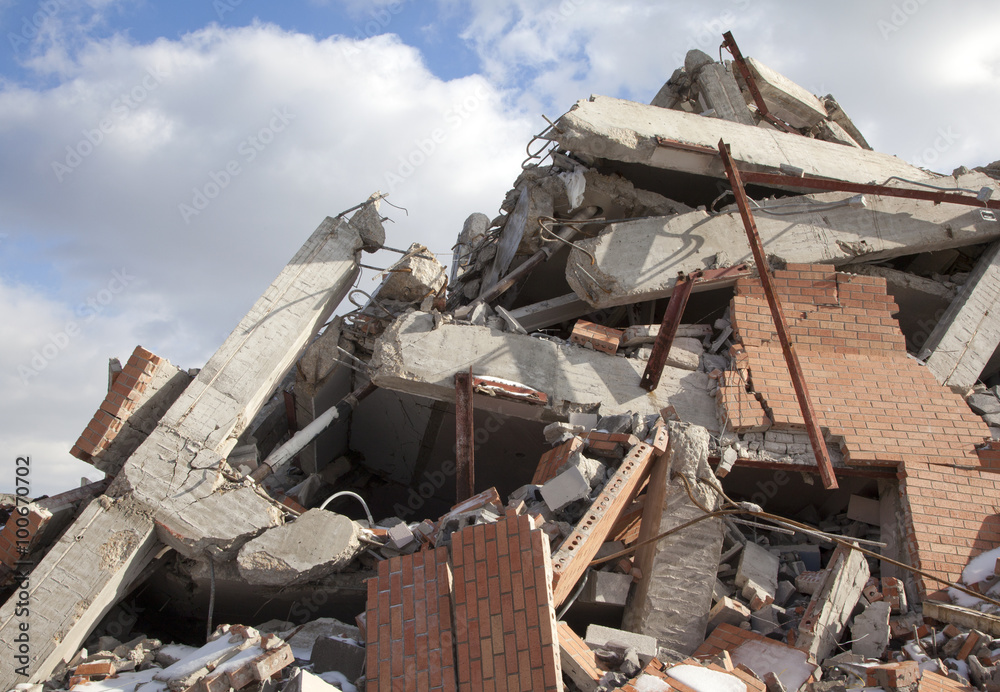 Rubble pile of wrecked building, blue sky and clouds, 2015. Rubble pile of wrecked building, blue sky and clouds, 2015.