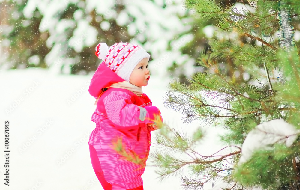 Cute little child walking in snowy winter forest Cute little child walking in snowy winter forest