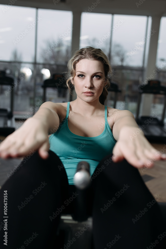 Beautiful woman doing press exercise in gym Beautiful woman doing press exercise in gym