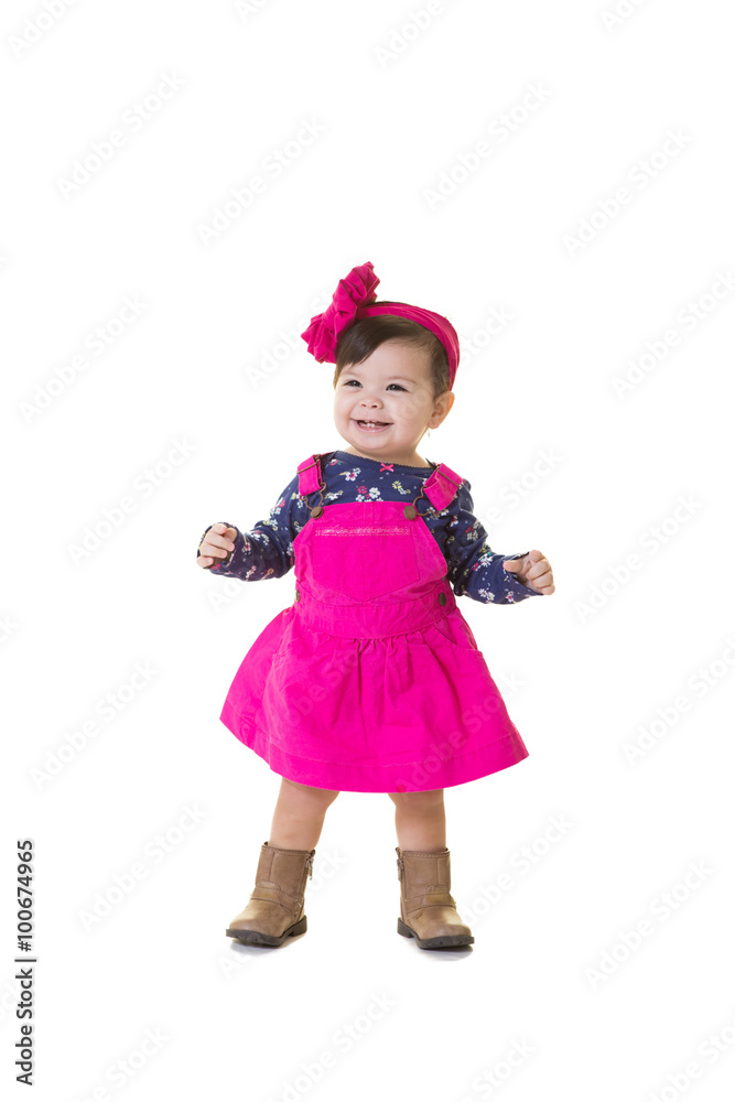 A portrait of a toddler learning to walk isolated on white A portrait of a toddler learning to walk isolated on white