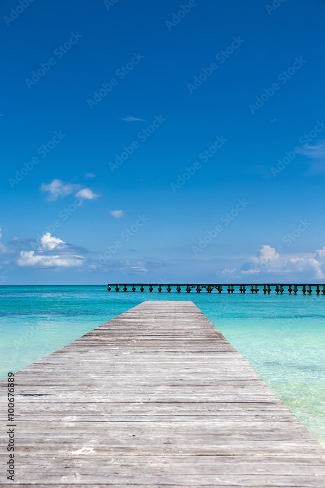 Wooden pier on tropical beach