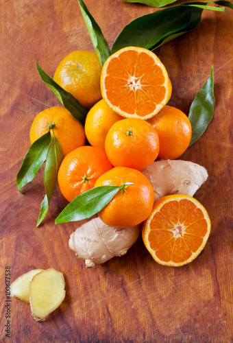 Fresh citrus with ginger on a wooden background