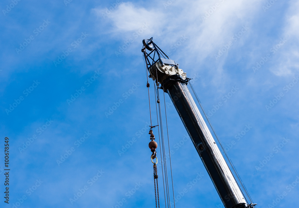 Top of large heavy industrial crane extended with hanging cables Top of large heavy industrial crane extended with hanging cables