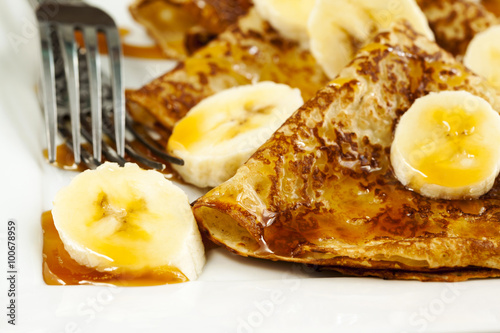 Crepes With Bananas and Caramel syrup close up