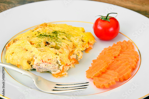 Baked salmon in cream with onions  carrots  cheese