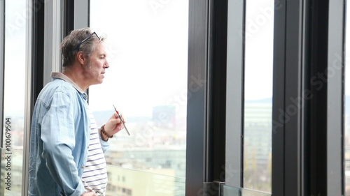 Wallpaper Mural Profile of creative director standing by window, smoking electronic cigarette Torontodigital.ca