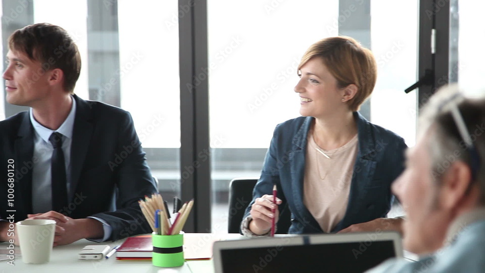 Business people sitting at table in conference room and listening presentation Business people sitting at table in conference room and listening presentation