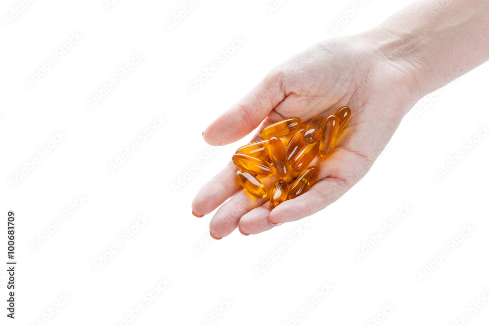 Fototapeta premium Soft gels pills with Omega-3 oil in hand closeup on white
