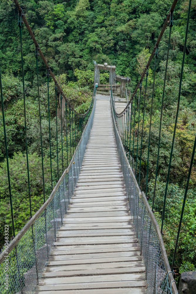 Suspension bridges leading to the viewpoint on Pailon del Diablo (Devil's Cauldron) waterfall near Banos town, Ecuador