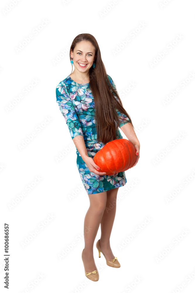 A preporation for halloween party. Smiling girl with a red pumpkin A preporation for halloween party. Smiling girl with a red pumpkin