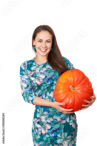 smiling girl with a large red pumpkin