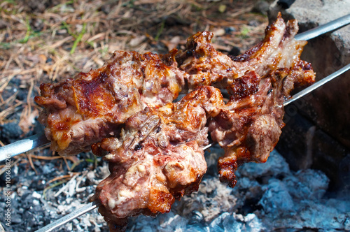 Pork ribs roasted on a fire.