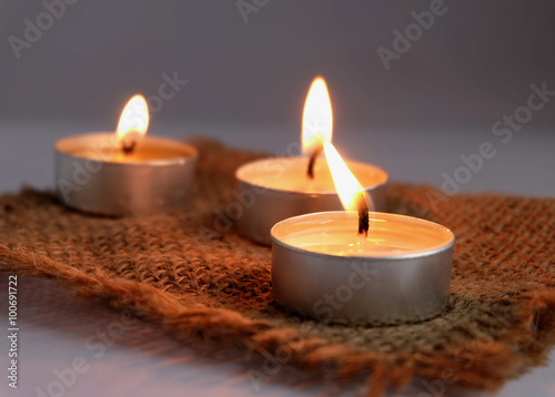  burning candles on sack cloth