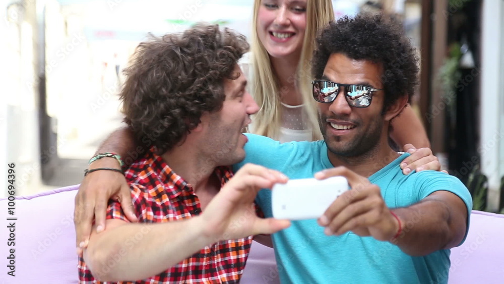 Three young adults having fun taking spontaneous selfies Three young adults having fun taking spontaneous selfies
