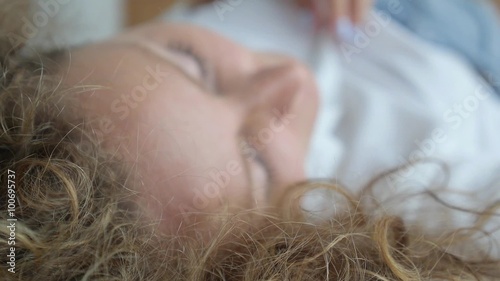Sexy Beautiful Sensual Woman Lying on Bed Unbuttons Blouse