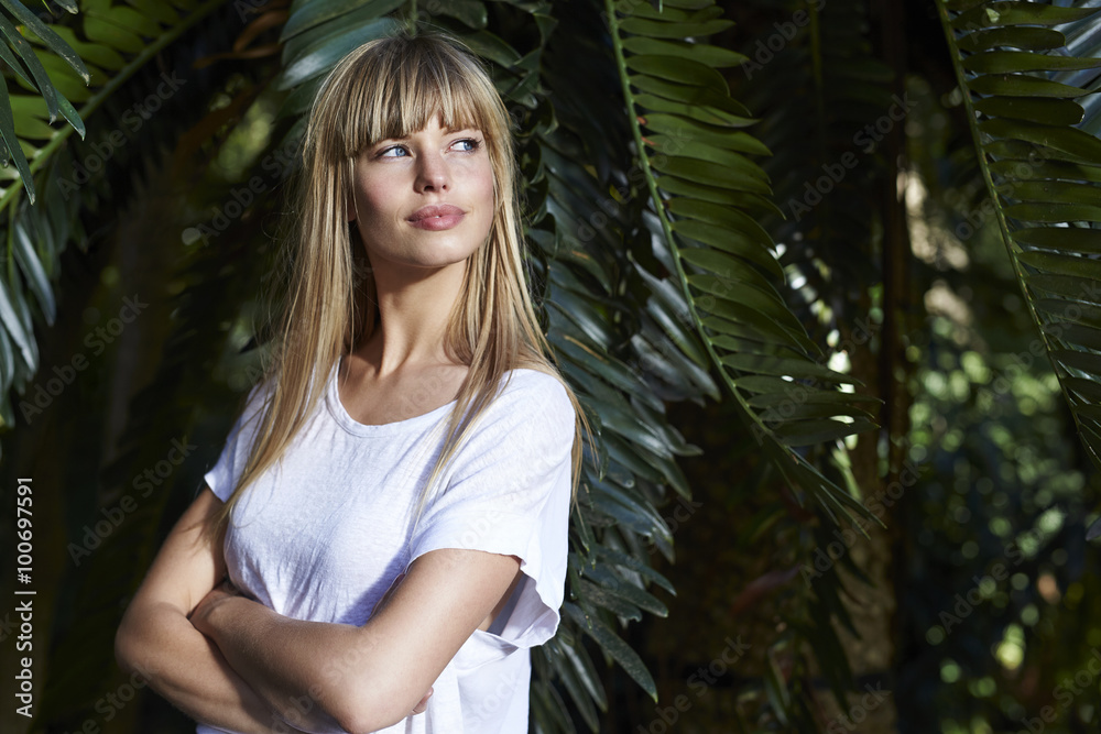 Blond beautiful woman by palm tree, looking away Blond beautiful woman by palm tree, looking away
