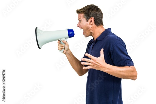 Obraz na plátně Side view of angry man shouting through megaphone