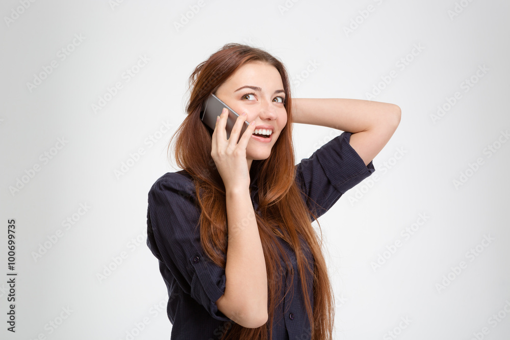 Cheerful attractive woman with long hair talking on cell phone Cheerful attractive woman with long hair talking on cell phone
