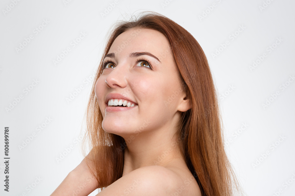 Portrait of cheerful happy young woman looking up Portrait of cheerful happy young woman looking up