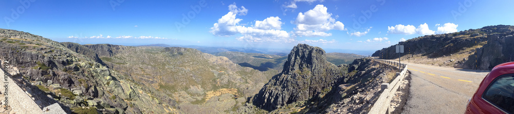 panoramic view of mountain landscape with Kantar Magra and red car on a streamer in the reserve of the Sierra de Eshtrella in Portugal
