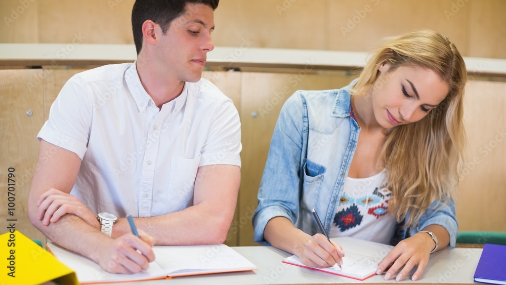 Male student cheating on his classmate Male student cheating on his classmate