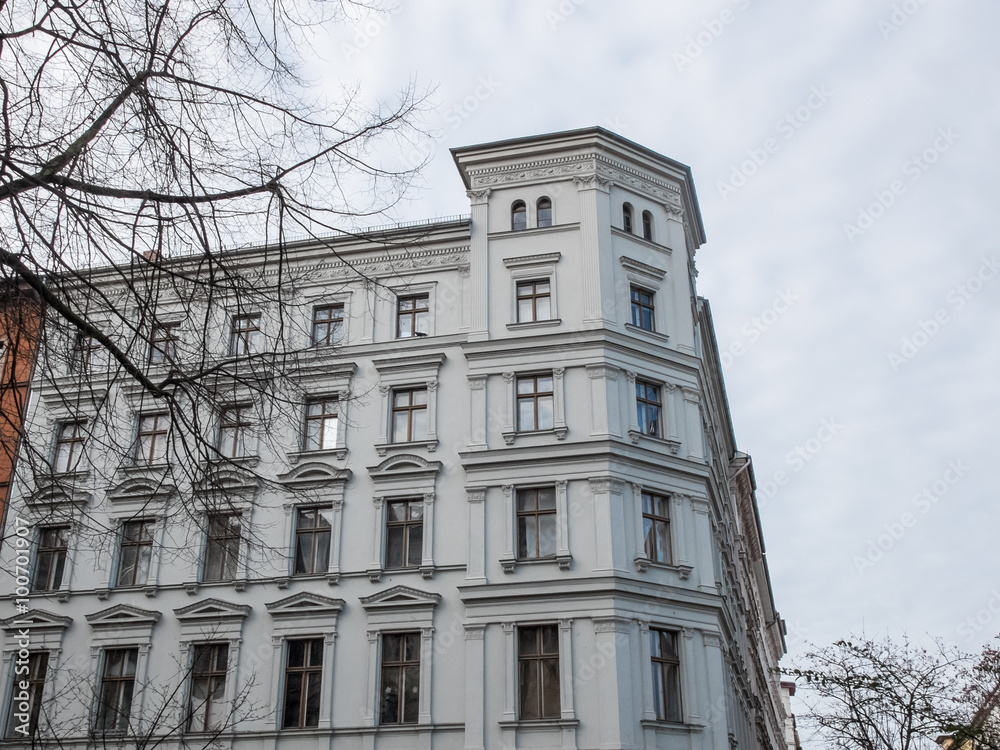 Bare Tree Branches Framing White Low Rise Building