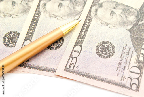 dollars banknotes and golden pen