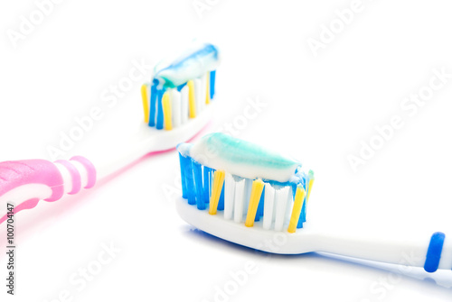 pair of toothbrushes with paste