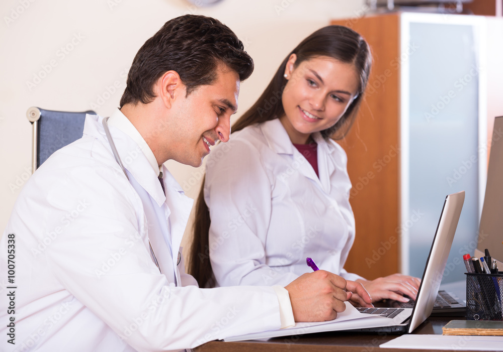 Obraz premium Family doctors with stethoscope working in office together