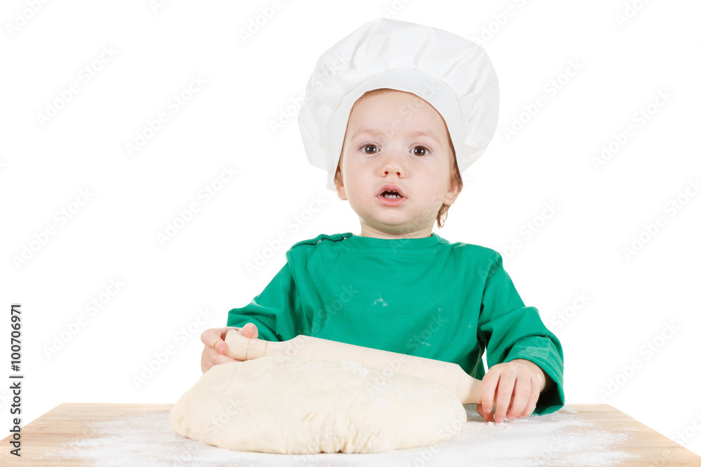 Smiling little boy kneading dough for the cookies, isolated on white Smiling little boy kneading dough for the cookies, isolated on white