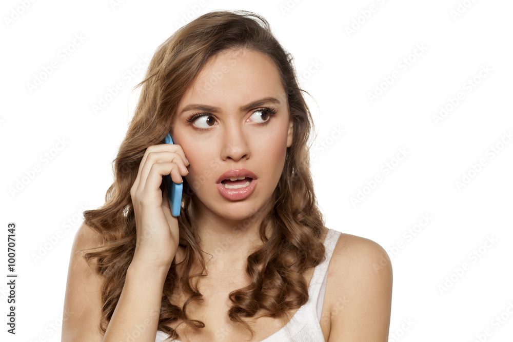 young woman has an unpleasant conversation on the phone young woman has an unpleasant conversation on the phone