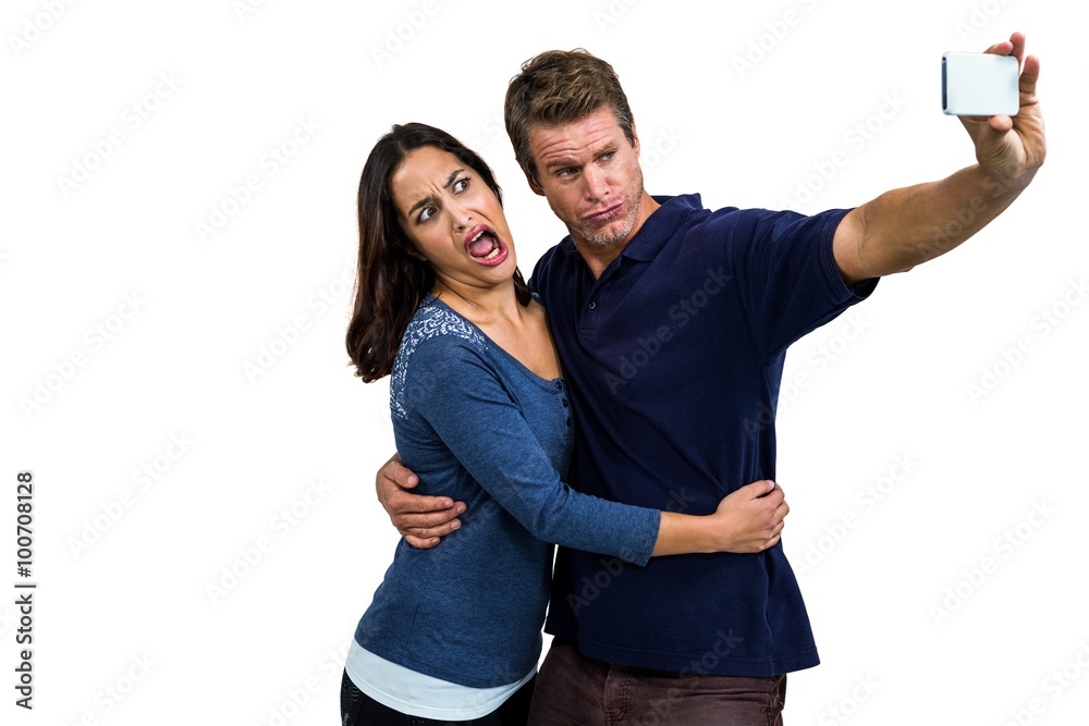 Young couple making face while taking selfie Young couple making face while taking selfie