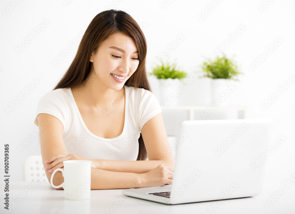 happy young woman with laptop in living room happy young woman with laptop in living room