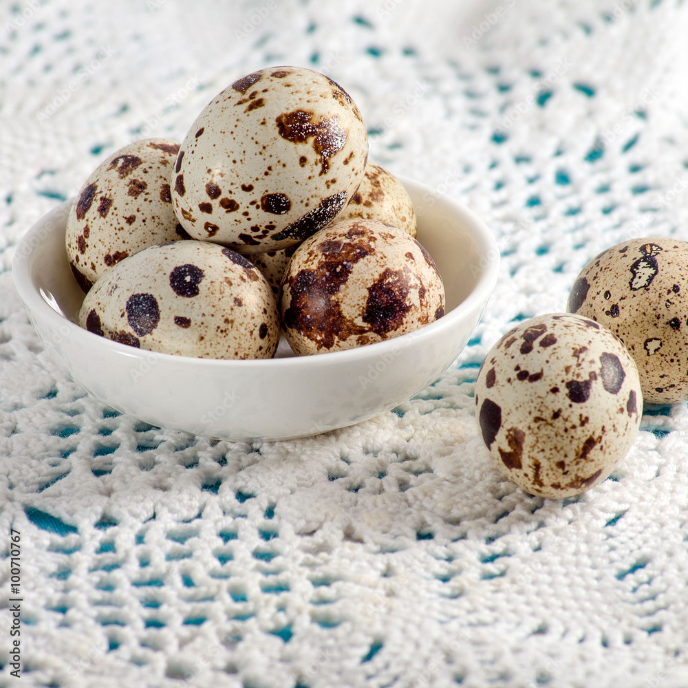 Quail eggs lying on a white plate Quail eggs lying on a white plate