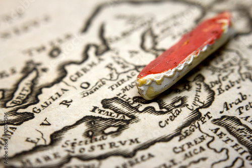 A boat and an antique map of Europe representing the immigration from the East
