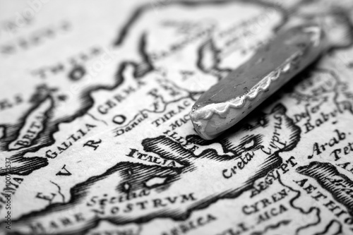 A boat and an antique map of Europe representing the immigration from the East