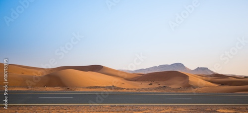 desert, sand dunes and the road in the evening