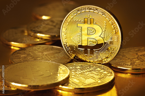 Golden Bitcoins on a gold background .Photo (new virtual money ) photo