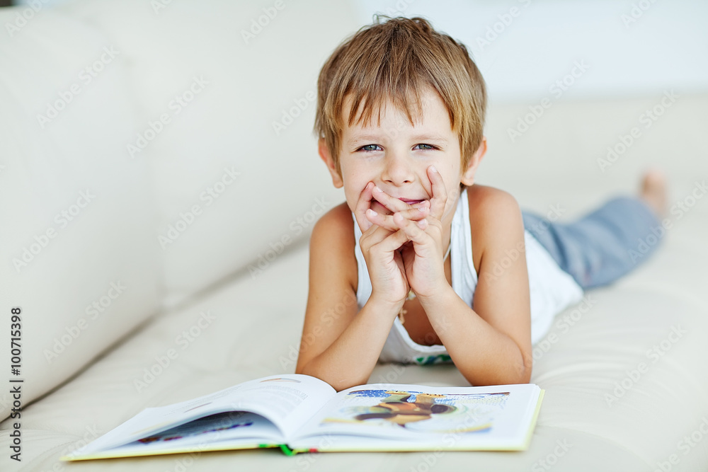 School boy are reading the book at home School boy are reading the book at home