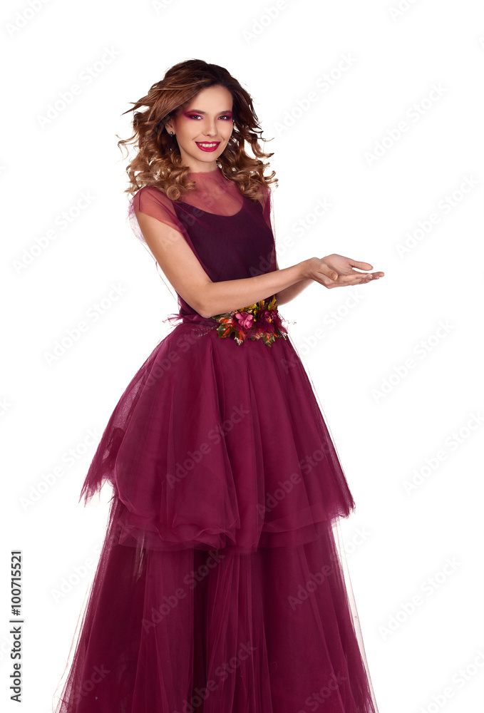 Young beautiful woman model in fairy red marsala dress showing empty copy space for product on the open hand palm, Isolated on white background.
