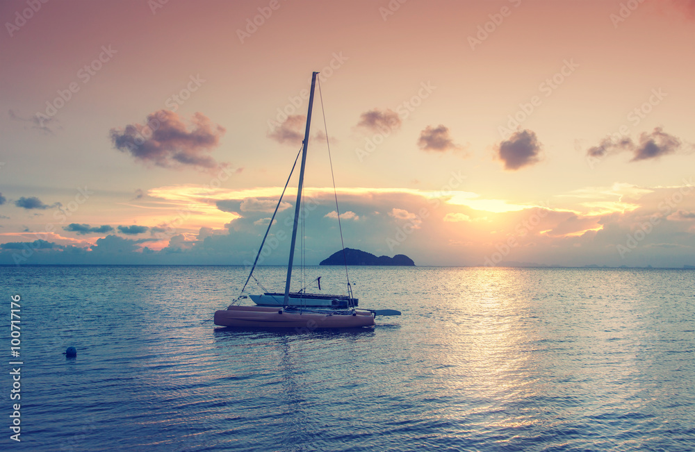 Boat on the beach against the backdrop of a beautiful sunset