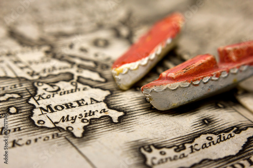 A boat and an antique map of Europe representing the immigration from the East