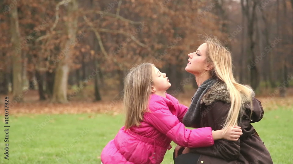 Little girl putting her hands through her mother's hair Little girl putting her hands through her mother's hair