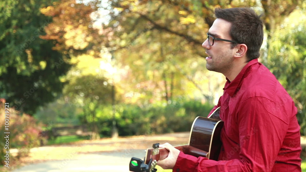 Man playing the guitar and singing Man playing the guitar and singing
