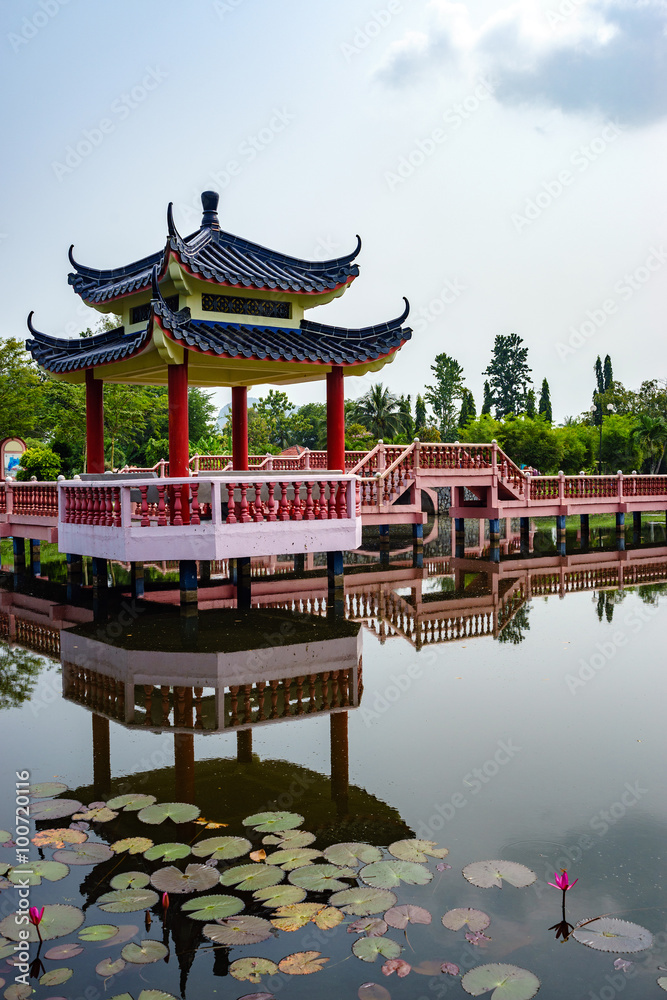 Beautiful garden with Chinese architecture bridge and reflection in the lake