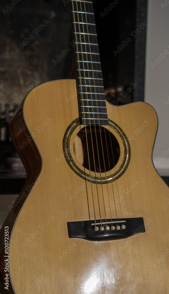 Fototapeta premium Guitar standing in front of fireplace