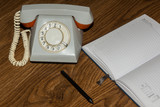 landline phone with a notebook