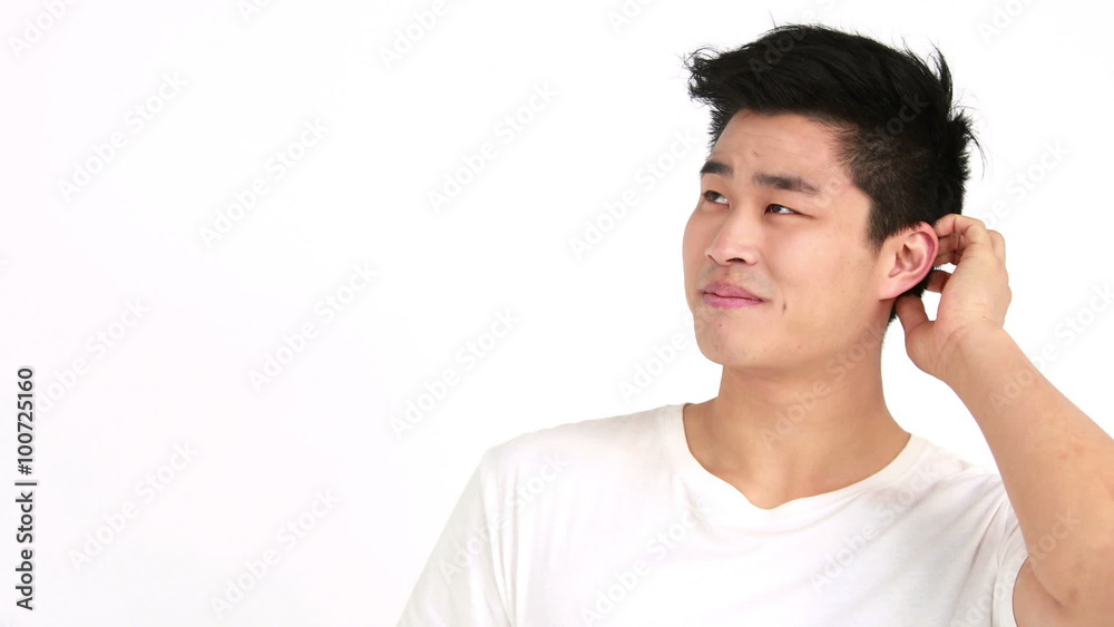 Smiling man scratching head and looking at camera Smiling man scratching head and looking at camera