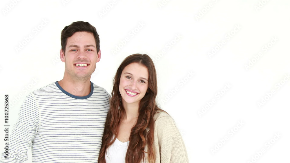 Happy couple smiling at camera and embracing Happy couple smiling at camera and embracing